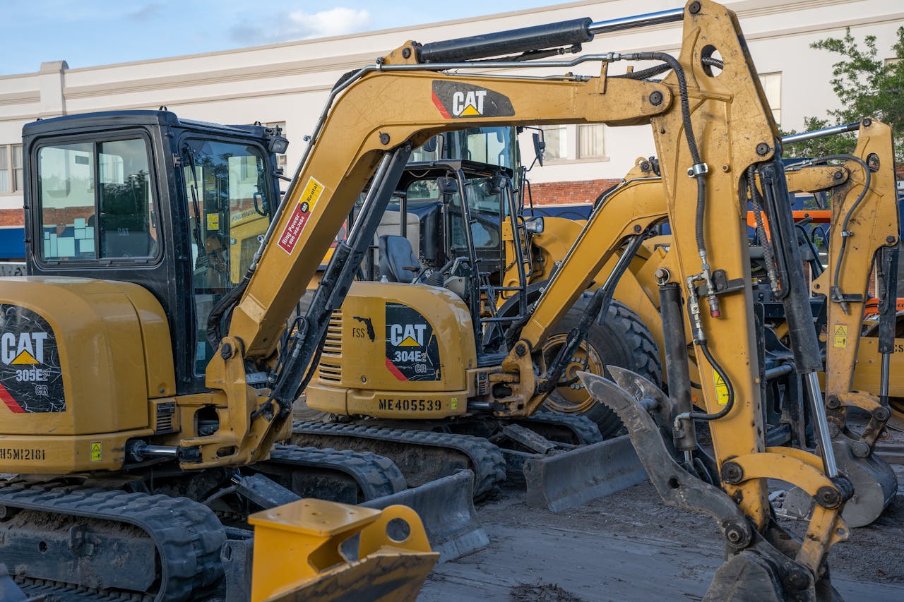 gallery-5 A row of parked excavators at a construction site, ready for heavy duty work.