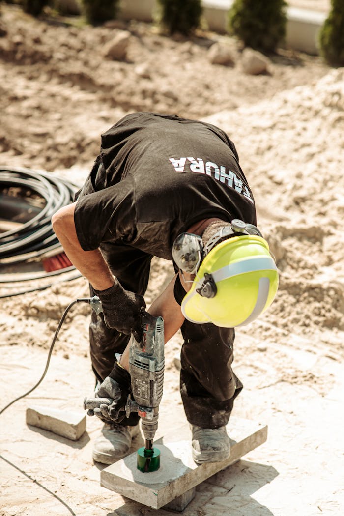 gallery-1 Worker operates a drill on a construction site in Grójec, Poland, showcasing industry.